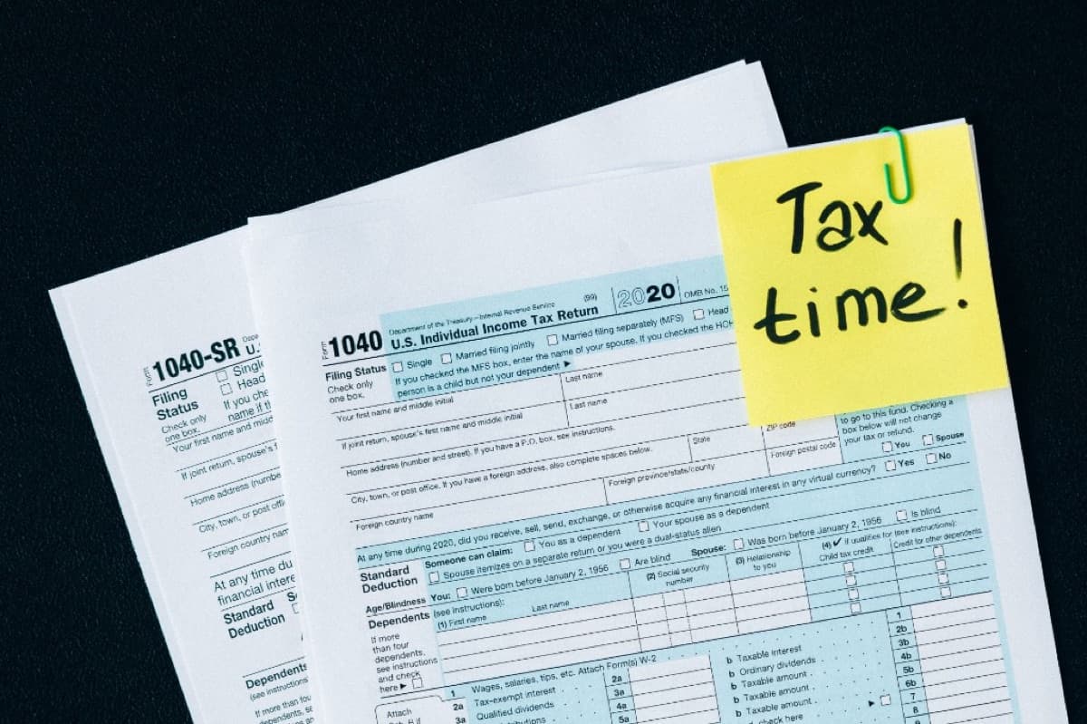 Tax forms with a sticky note reading Tax time, representing preparation for tax season