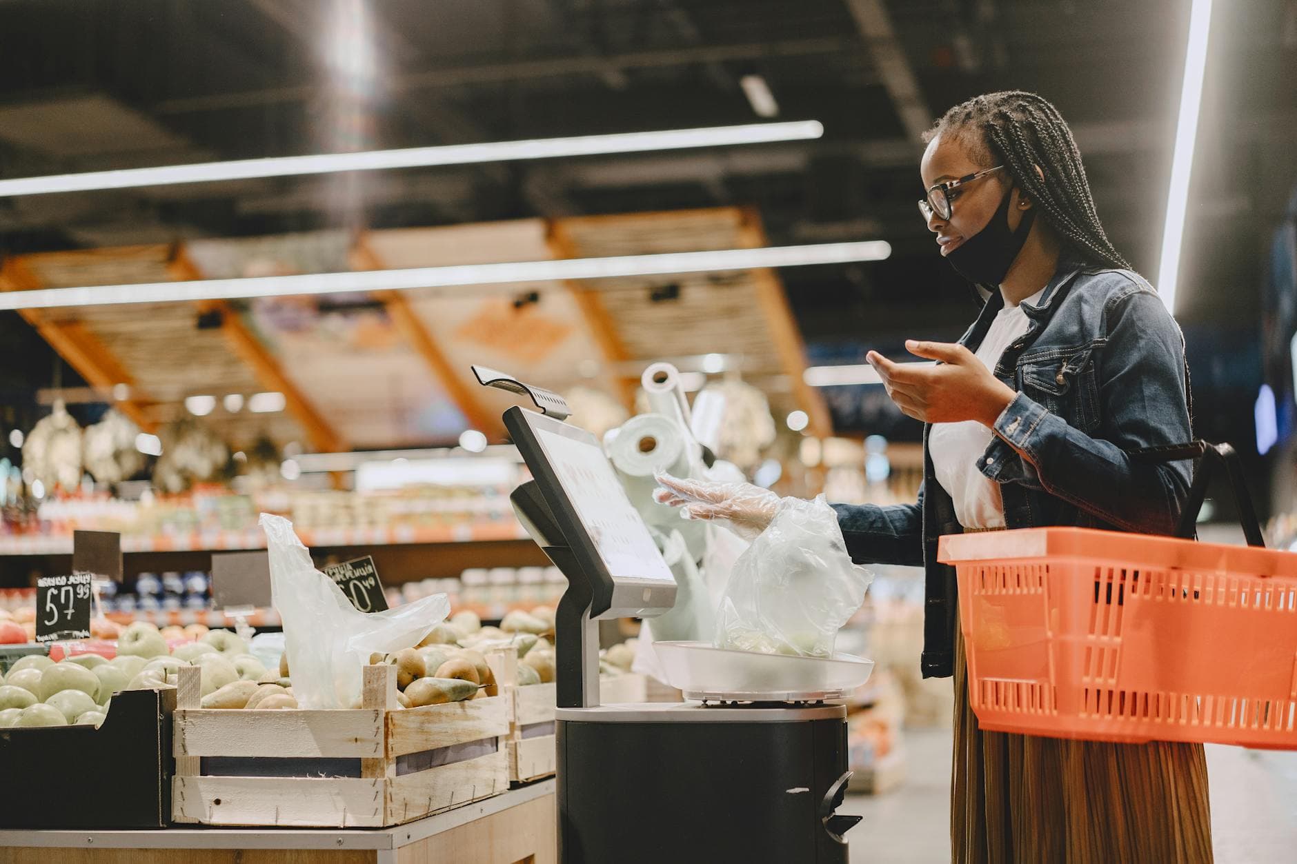 A shopper paying at a grocery store checkout with a smartphone