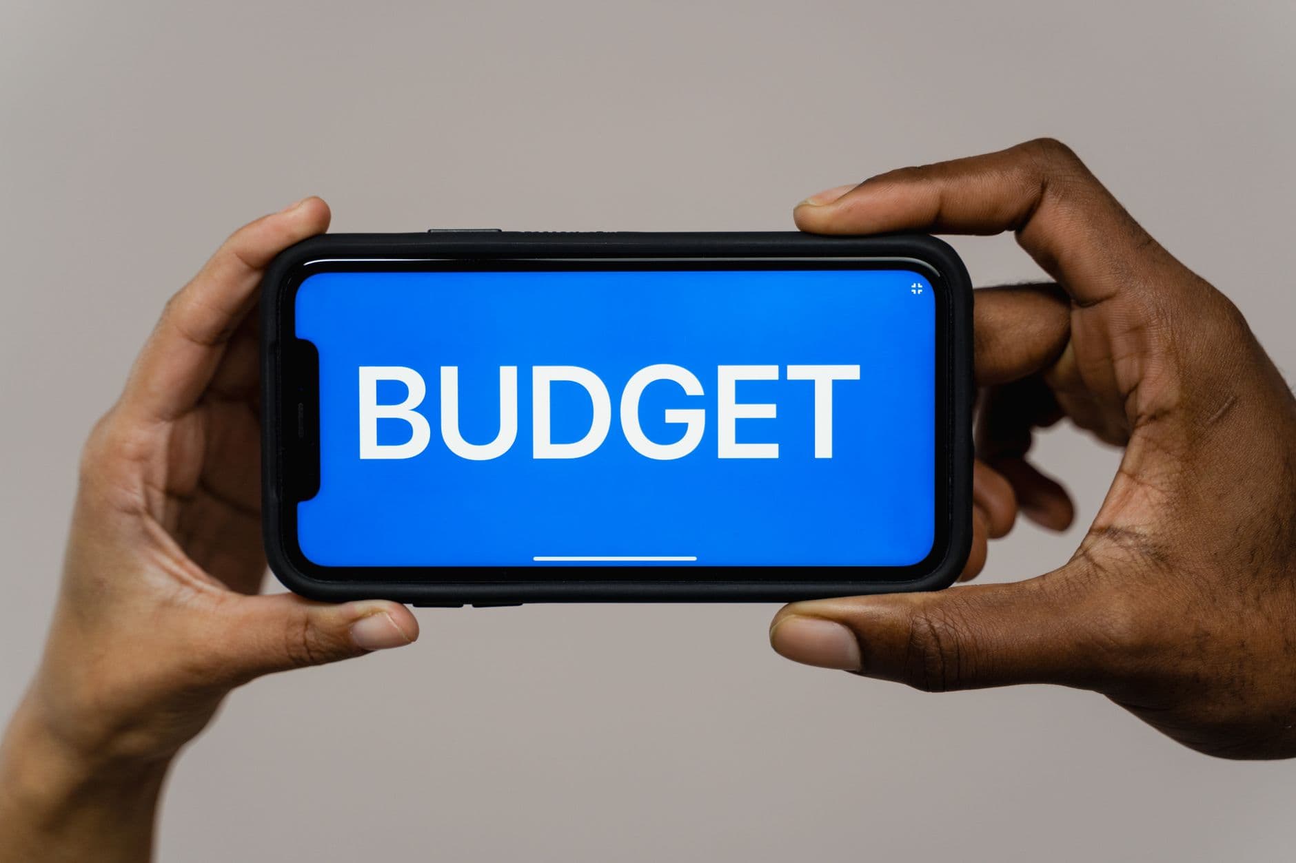 Person using a personal finance budgeting app on a smartphone