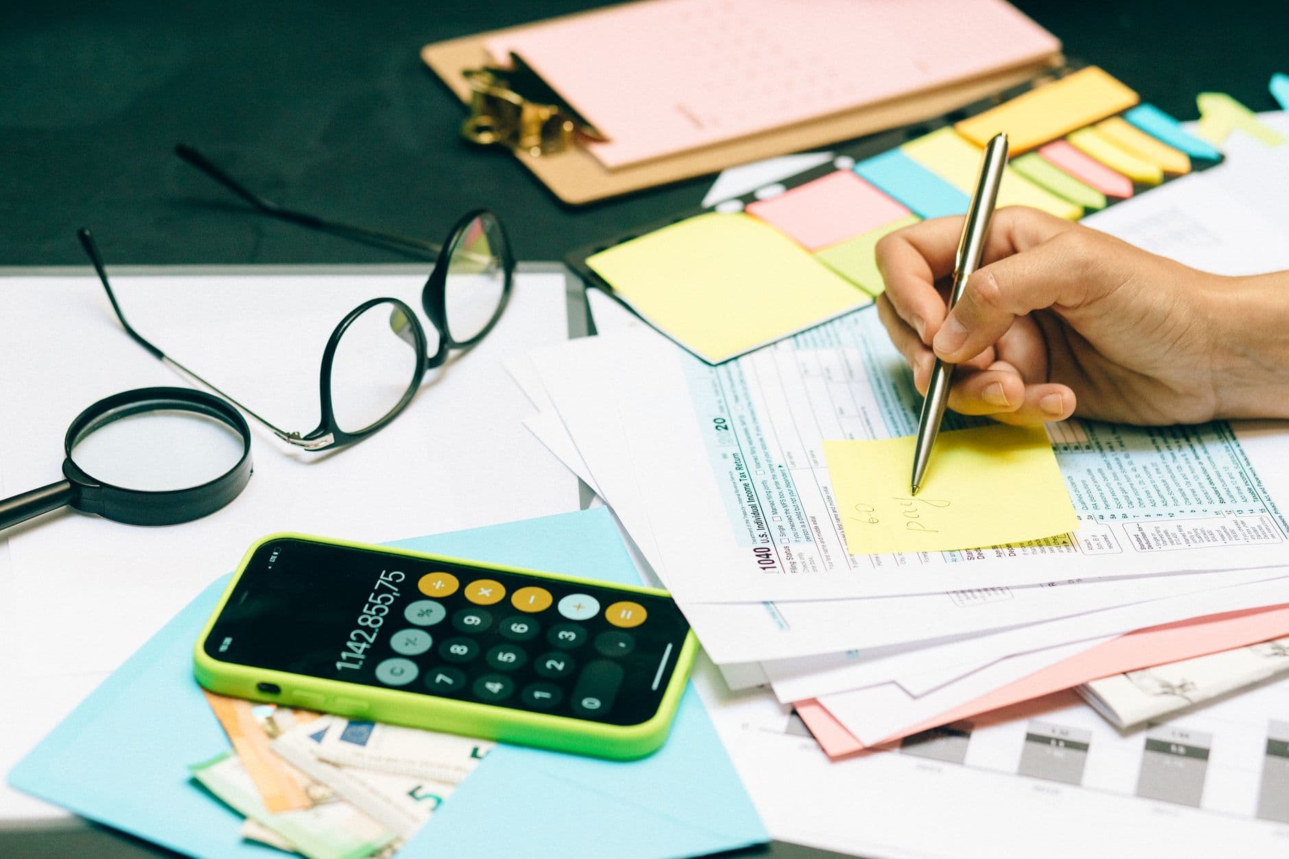 Etsy seller reviewing payout deposits and tax documents at a desk