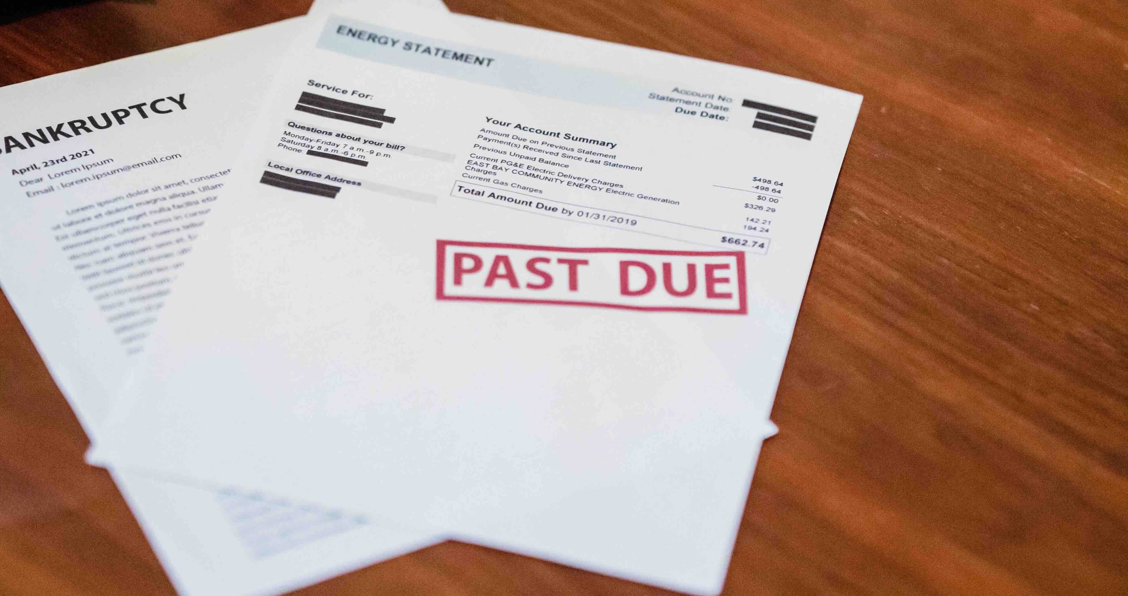 Past-due bill notice on a kitchen counter, a reminder to set up a monthly bill tracker
