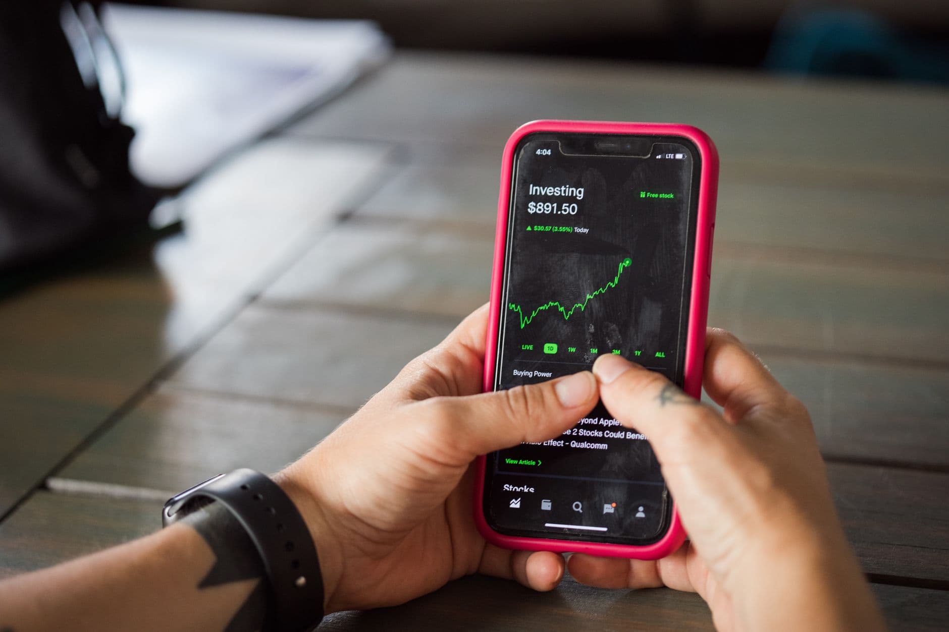 Person reviewing AI-powered budgeting app on a smartphone