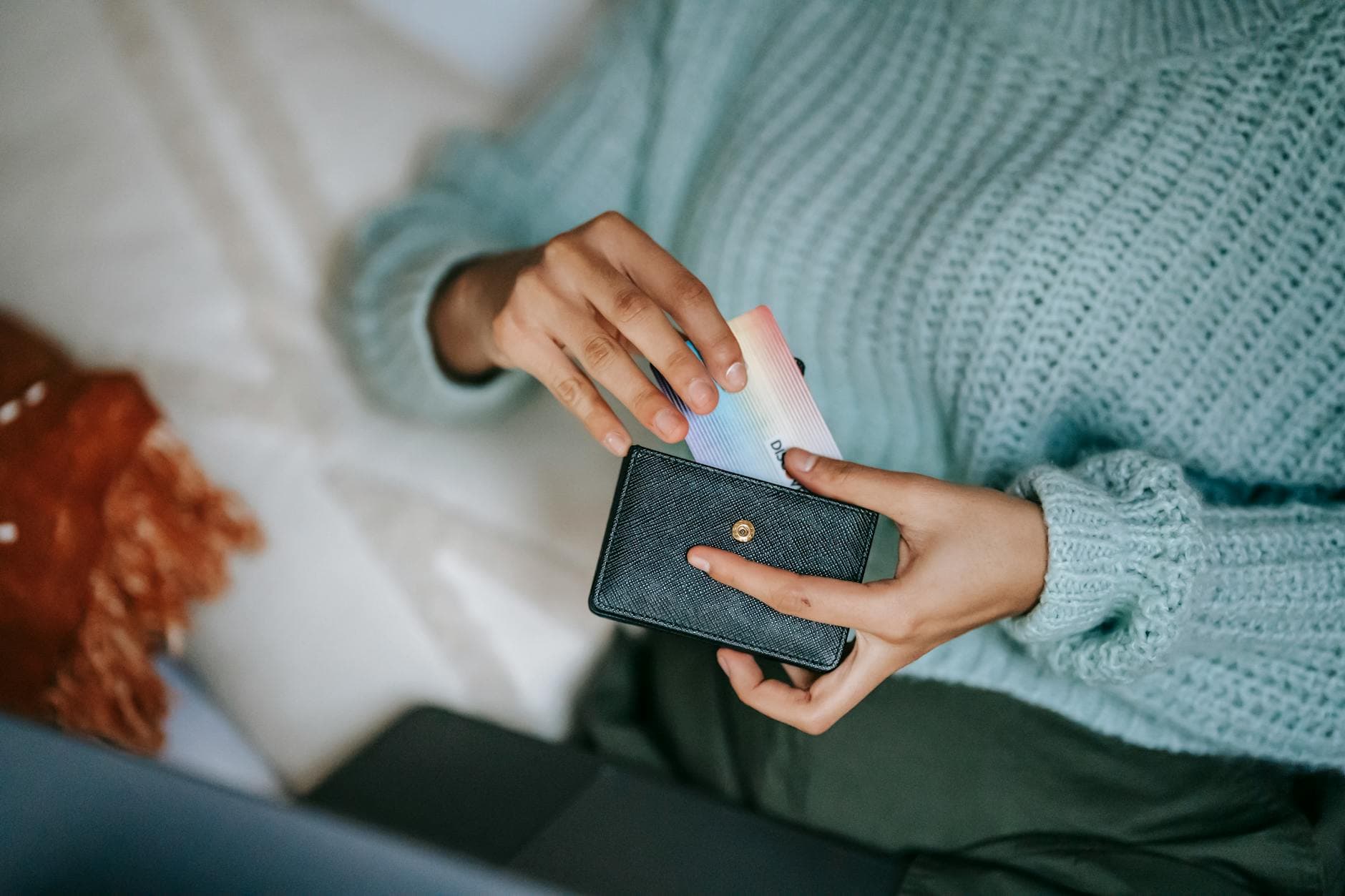 A middle-income household reviewing credit card statements and monthly bills at a kitchen table