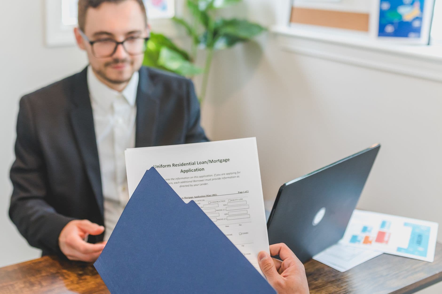 A person reviewing student loan repayment documents at a desk