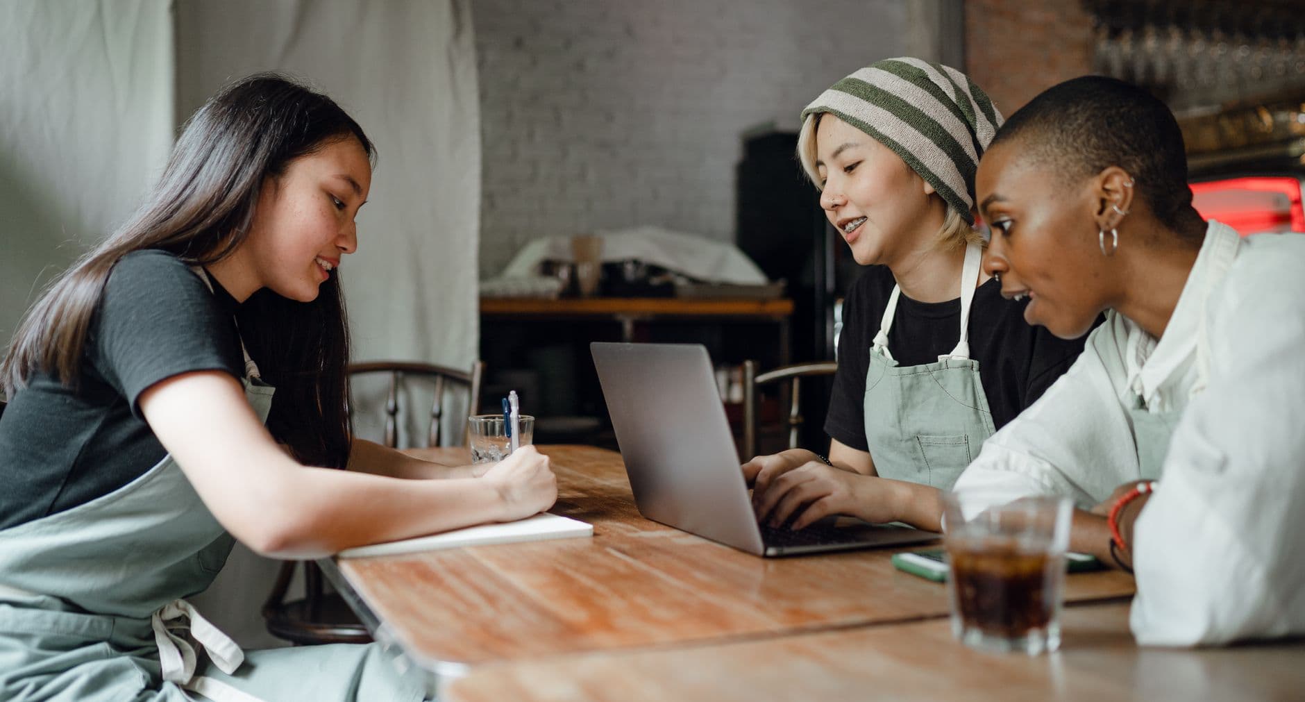 Small business team collaborating at a laptop in a bright workspace