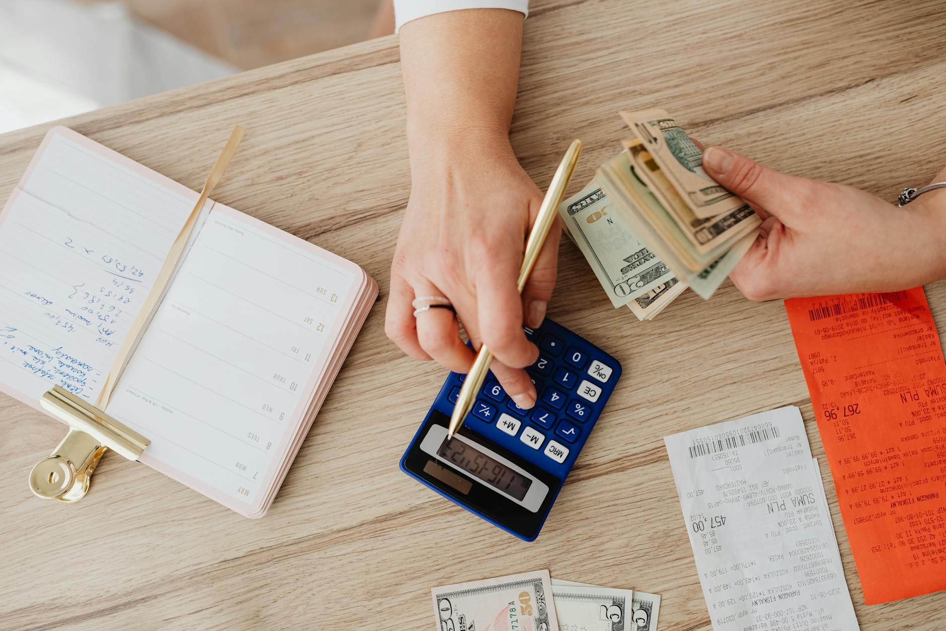 A middle-income household reviewing credit card statements and monthly bills at a kitchen table