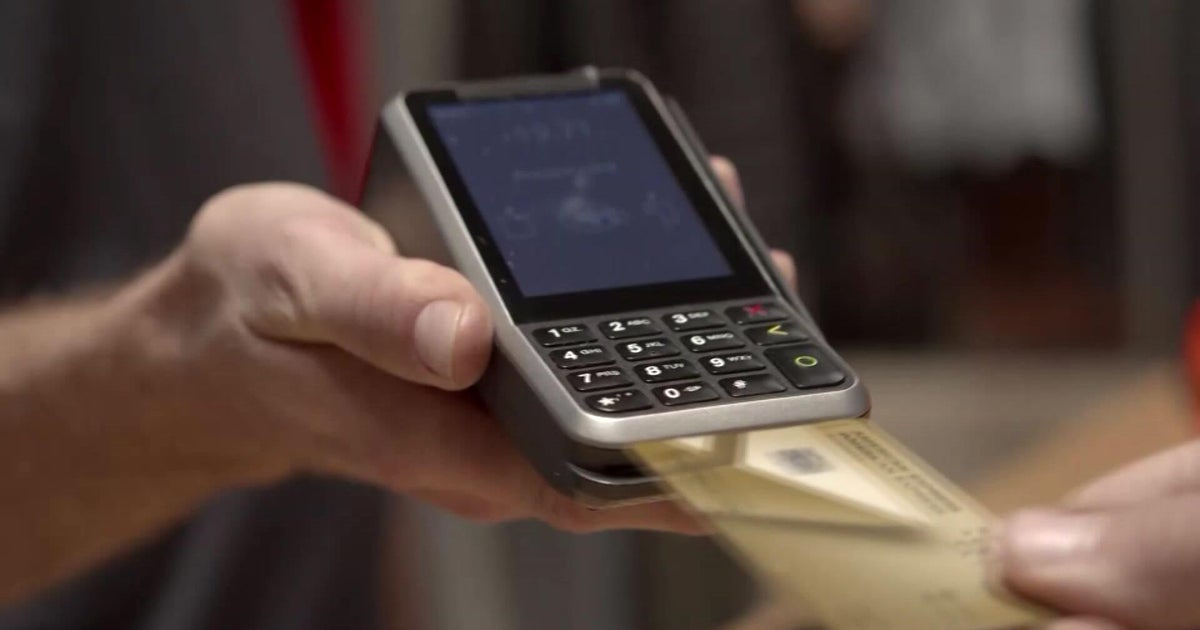 Person using a smartphone to complete a buy now pay later transaction at checkout